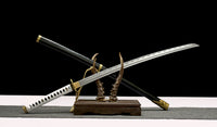 Two swords on a stand with a black background